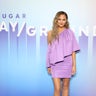 Chrissy Teigen stuns in a purple mini while attending the POPSUGAR Play/Ground event at Pier 94 in New York City on June 23, 2019. 