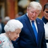 Queen Elizabeth II speaking to President Trump and first lady Melania Trump as they viewed U.S memorabilia from the Royal Collection at Buckingham Palace.
