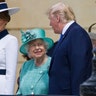 Queen Elizabeth II smiling while talking with President Trump at Buckingham Palace, with first lady Melania Trump on her other side.