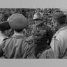 Fortitude South -?The southern counterpart to Fortitude North was to convince the Germans that the main invasion would come at the Pas de Calais region of France, east of Normandy, while the Normandy landings were only a feint. It has been argued that Fortitude South had the advantage of being the plan that German dictator Adolf Hitler wanted to believe would occur and thus he never accepted that Normandy was the actual invasion.The invasion was to be carried out by the First United States Army Group (FUSAG), under the command of the very real General George S. Patton. This photo from August 1944 shows Patton talking to Allied war correspondents in Normandy.