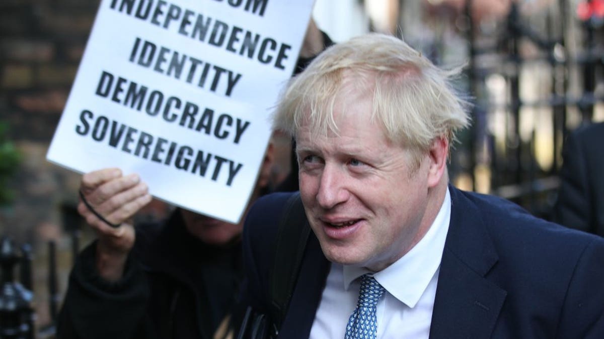 Conservative party leadership contender Boris Johnson, is shadowed by a Brexit demonstrator, as he arrives at his office in central London, Tuesday July 23, 2019. Britain’s governing Conservative Party is set to reveal the name of the country’s next prime minister later Tuesday, with Brexit champion Boris Johnson widely considered to be favourite to get the job against fellow contender Jeremy Hunt.