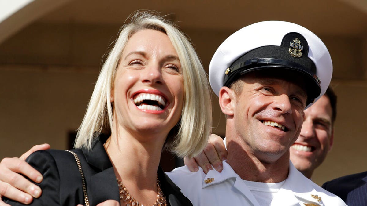 Navy Special Operations Chief Edward Gallagher, left, and his wife, Andrea Gallagher smile after leaving a military court on Naval Base San Diego, Tuesday, July 2, 2019, in San Diego. A military jury acquitted a decorated Navy SEAL of premeditated murder Tuesday in the killing of a wounded Islamic State captive under his care in Iraq in 2017. (AP Photo/Gregory Bull)