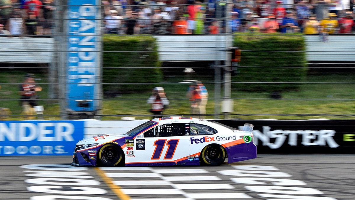 Denny Hamlin crosses the finish line to win a NASCAR Cup Series auto race, Sunday, July 28, 2019, in Long Pond, Pa. (AP Photo/Derik Hamilton)
