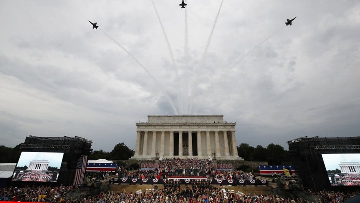 President Donald Trump, first lady Melania Trump, Vice President Mike Pence and Karen Pence and others stand as the US Army Band performs and the US Navy Blue Angels flyover at the end of an Independence Day celebration in front of the Lincoln Memorial, Thursday, July 4, 2019, in Washington.