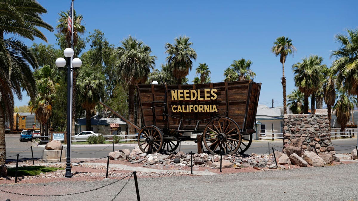 A sign adorns a historic wagon along old Route 66 in Needles, Calif. (Associated Press)