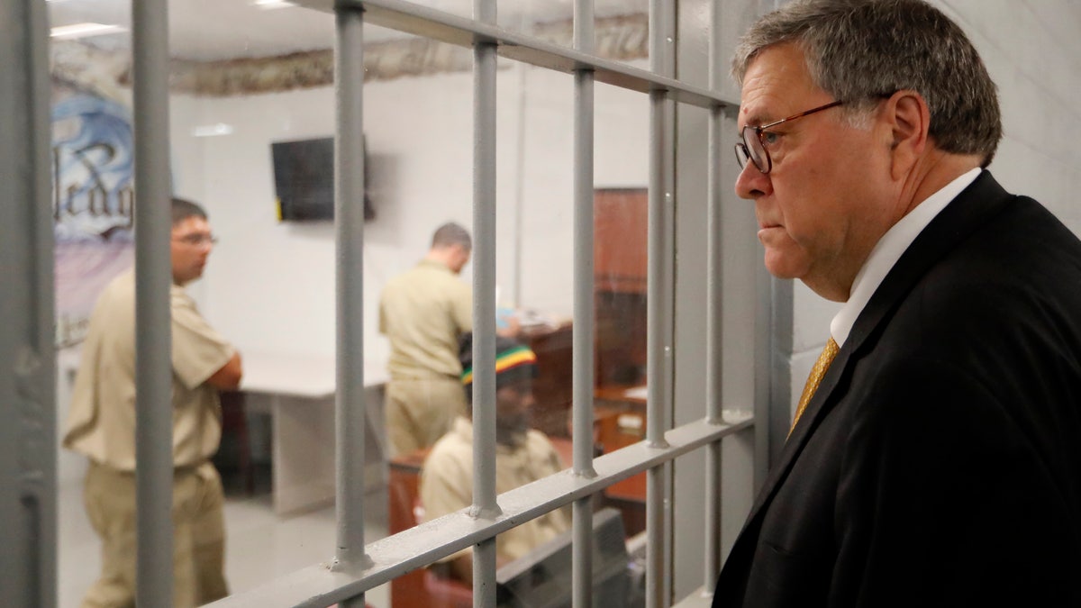 Attorney General William Barr watching inmates working in a computer class during a tour of a federal prison Monday in Edgefield, S.C. (AP Photo/John Bazemore)