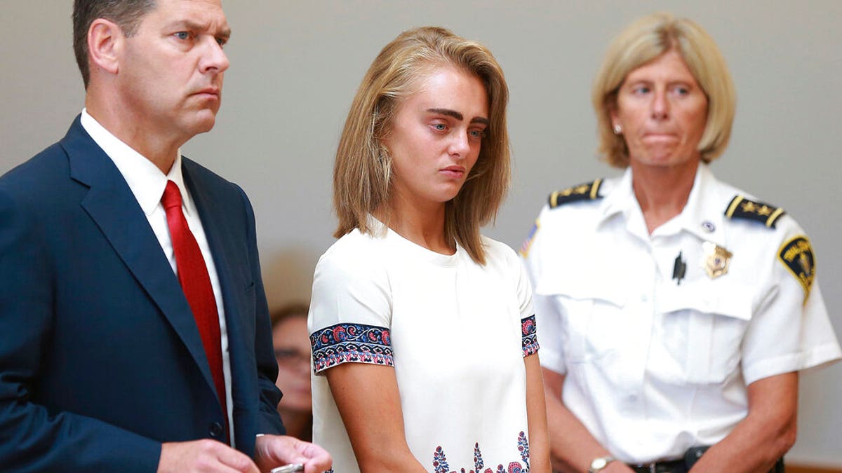 FILE: Michelle Carter, center, listens to her sentencing for involuntary manslaughter for encouraging 18-year-old Conrad Roy III to kill himself in July of 2014. 