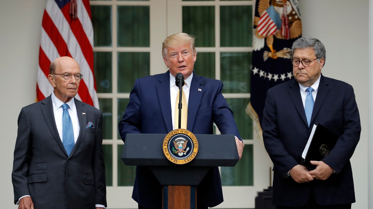 President Donald Trump is joined by Commerce Secretary Wilbur Ross and Attorney General William Barr, right, as he speaks in the Rose Garden at the White House in Washington, Thursday, July 11, 2019. (AP Photo/Carolyn Kaster)