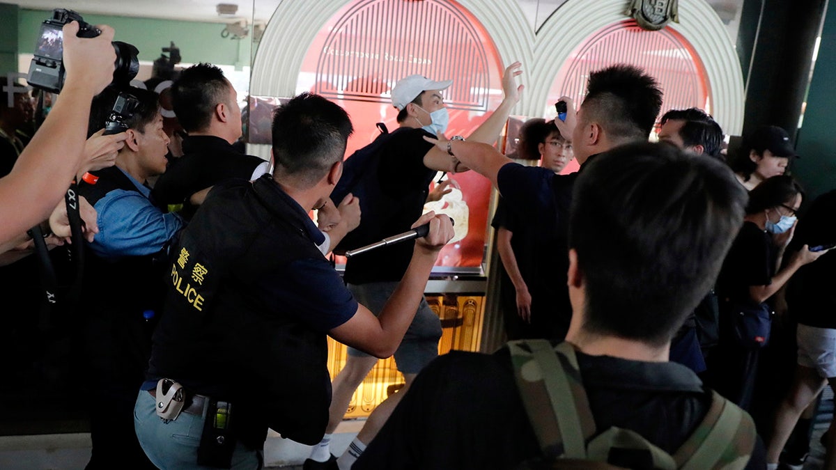 Police attack a protester in Hong Kong Saturday, July 13, 2019. Several thousand people marched in Hong Kong on Saturday against traders from mainland China in what is fast becoming a summer of unrest in the semi-autonomous Chinese territory. (AP Photo/Kin Cheung)