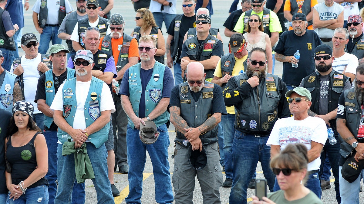 Attendees observe a moment of silence during Saturday's memorial and remembrance service.