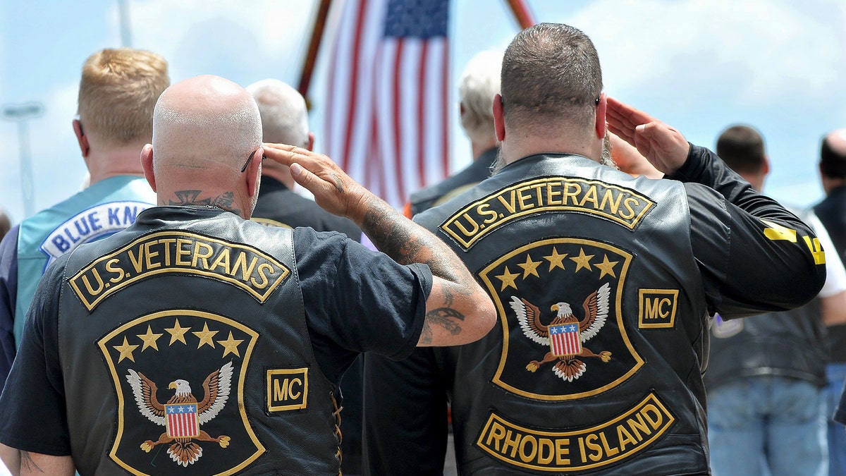 Members of the U.S. Veterans Motorcycle Club salute the flag during the playing of the National Anthem. (Mark Stockwell/The Sun Chronicle via AP)