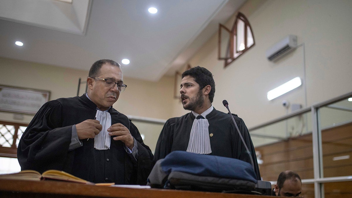 Lawyers gather inside a courtroom before the start of a final trial session for suspects charged in connection with the killing of two Scandinavian tourists in Morocco, in Sale, near Rabat, Morocco, Thursday, July 18, 2019.