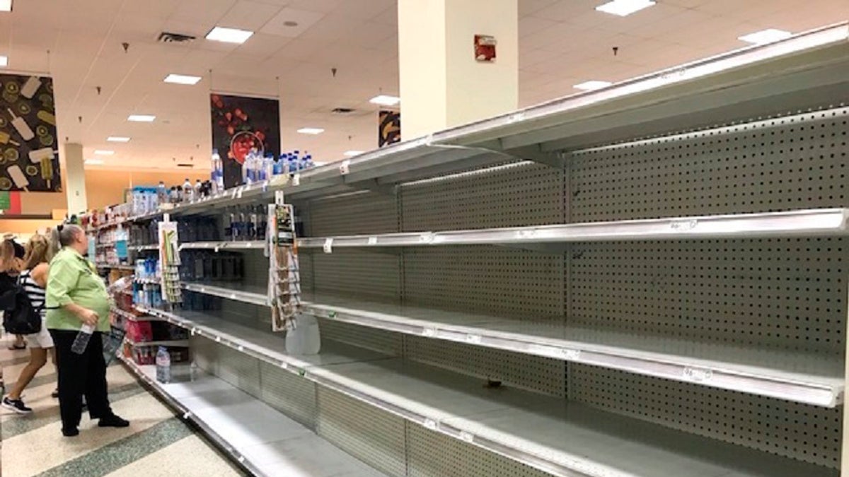 Shoppers look at empty shelfs as a high demand for large jugs of water are sold out at the Coral Ridge Mall Publix after a water main break Thursday, July 18, 2019 in Fort Lauderdale, Fla. (Linda Trischitta/South Florida Sun-Sentinel via AP)