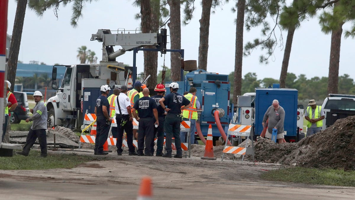 Fort Lauderdale fire rescue work the scene of a water main break near the Fort Lauderdale Executive Airport Thursday, July 18, 2019. (Carline Jean/South Florida Sun-Sentinel via AP)