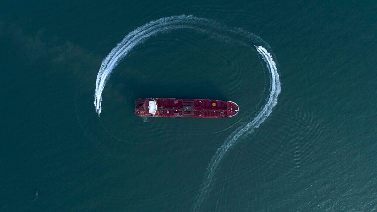 FILE: An aerial view shows a speedboat of Iran's Revolutionary Guard moving around the British-flagged oil tanker Stena Impero which was seized in the Strait of Hormuz on Friday by the Guard, in the Iranian port of Bandar Abbas. 