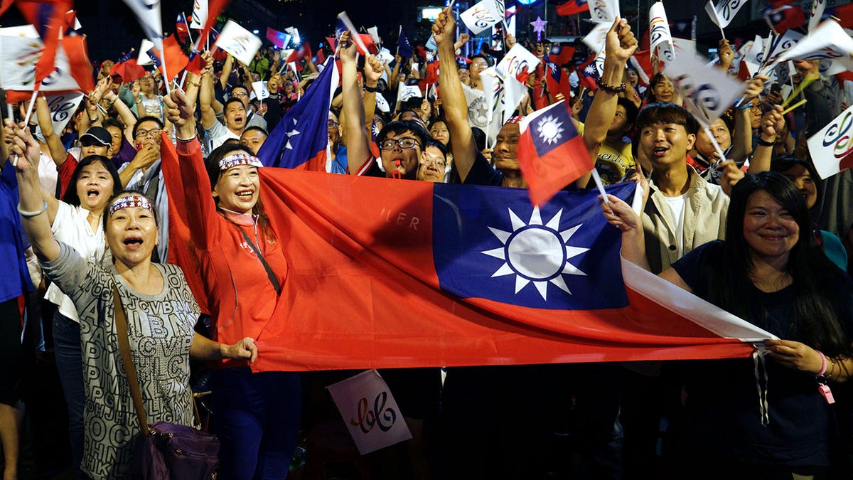  supporters of the opposition Nationalist Party cheer in Kaohsiung, Taiwan. 