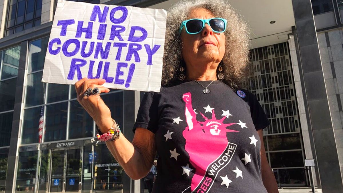 Arla Ertz holding a protest sign outside of the San Francisco Federal Courthouse on Wednesday.