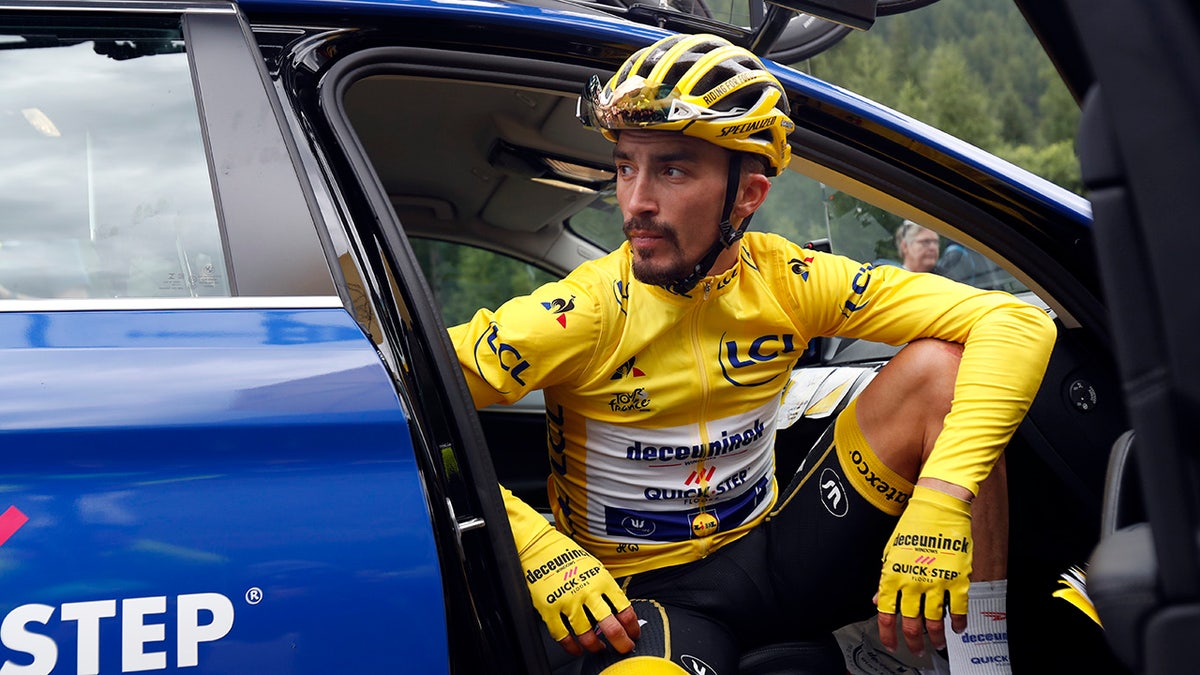 France's Julian Alaphilippe wearing the overall leader's yellow jersey sits in the team director car during the nineteenth stage of the Tour de France cycling race over 126,5 kilometers (78,60 miles) with start in Saint Jean De Maurienne and finish in Tignes, France, Friday, July 26, 2019. Tour de France organizers stopped Stage 19 of the race because of a hail storm as Julien Alaphilippe lost his yellow jersey to Egan Bernal. (AP Photo/Thibault Camus)
