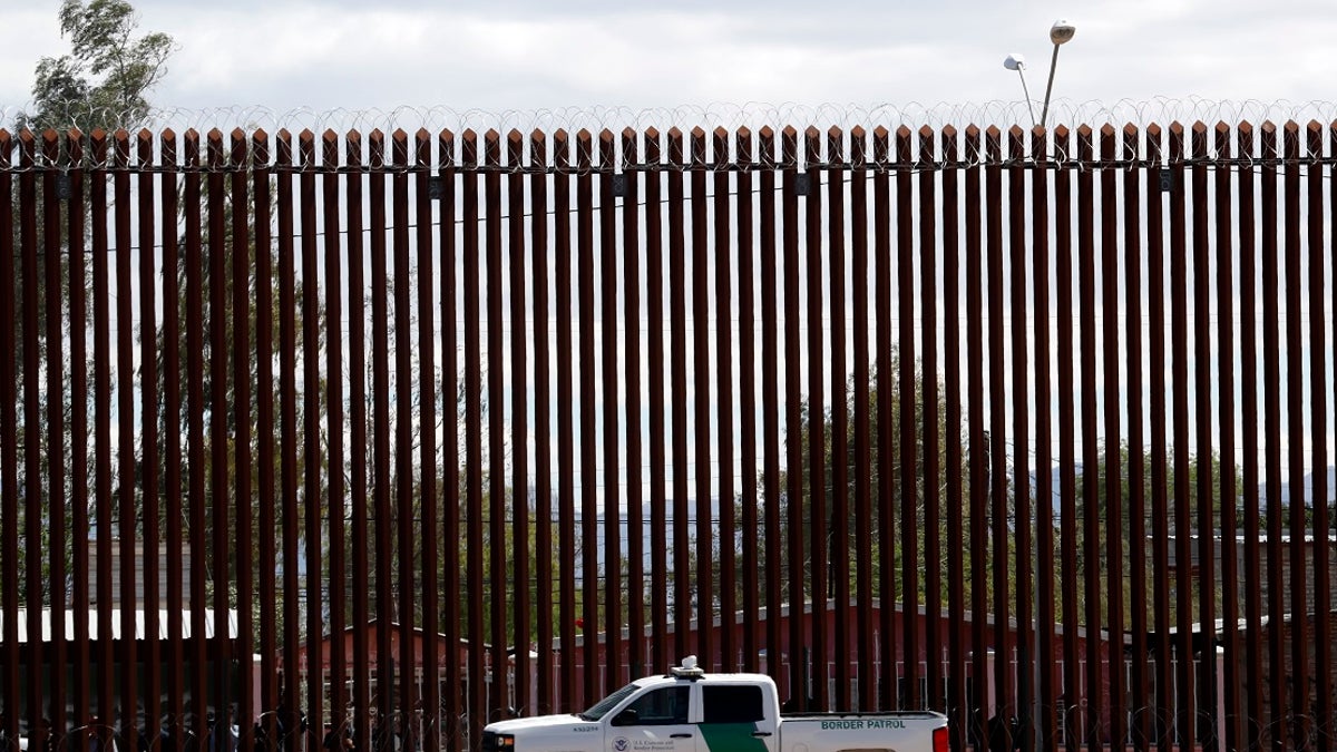 A border agent's truck sits near the U.S. southern border