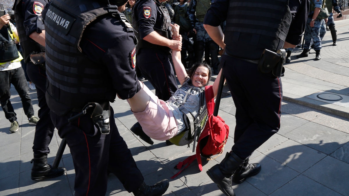 Russian police are wrestling with demonstrators and have arrested hundreds in central Moscow during a protest demanding that opposition candidates be allowed to run for the Moscow city council. (AP Photo/Alexander Zemlianichenko)