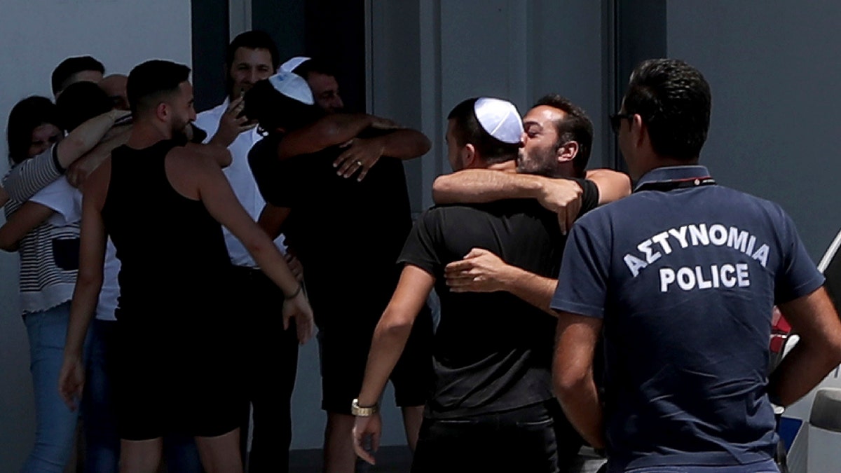 An Israeli teenager embraced by relatives after being released from Famagusta police headquarters in Paralimni, Cyprus, on Sunday. (AP Photo/Petros Karadjias)