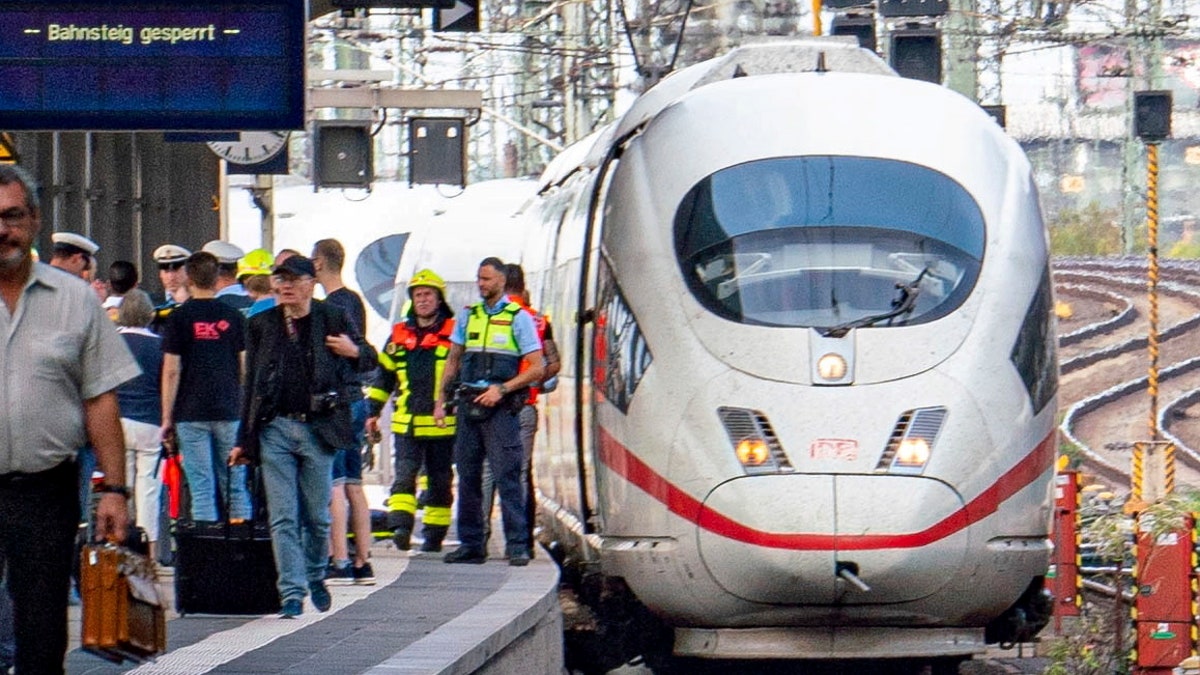 Firefighters and Police officers stay next to an ICE highspeed train at the main station in Frankfurt, Germany.