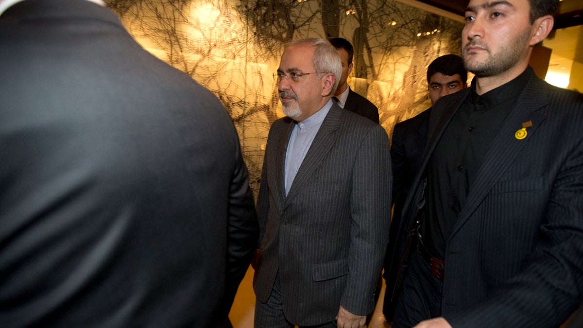 In this Nov. 9, 2013, photo, Iranian Foreign Minister Mohammad Javad Zarif, center, leaves following a meeting with E.U. foreign ministers in Geneva. (Jason Reed/Poo Photo via APl, File)