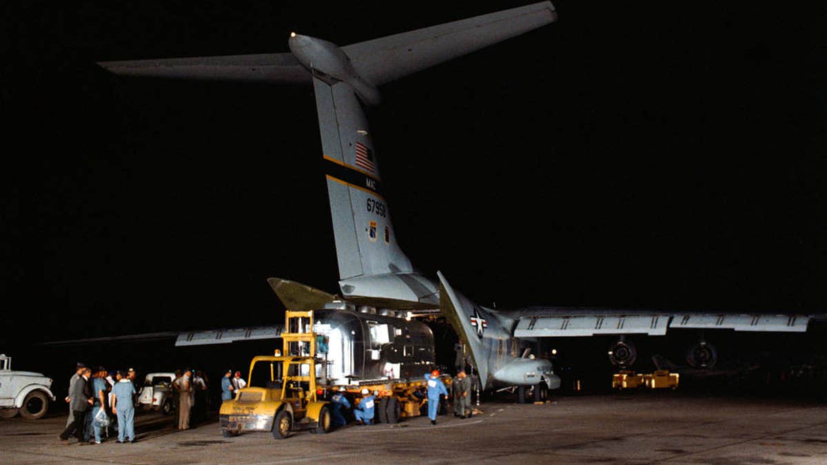 The MQF with the three Apollo 11 astronauts is unloaded from a U.S. Air Force C-141 jet transport at Ellington Air Force Base. (NASA)