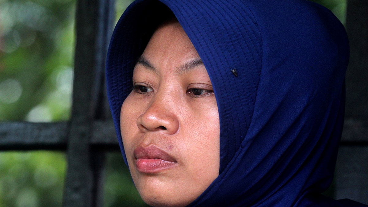 Baiq Nuril Maknun, who exposed her cheating boss, looks stunned after she got slapped with a six-month jail term for violating a controversial law against spreading indecent material, in Mataram on Lombok island on November 16, 2018. - The supreme court's shock decision overturned an earlier court ruling that cleared the woman of breaking the controversial law against spreading indecent material. (Photo by Pikong / AFP) (Photo credit should read PIKONG/AFP/Getty Images)