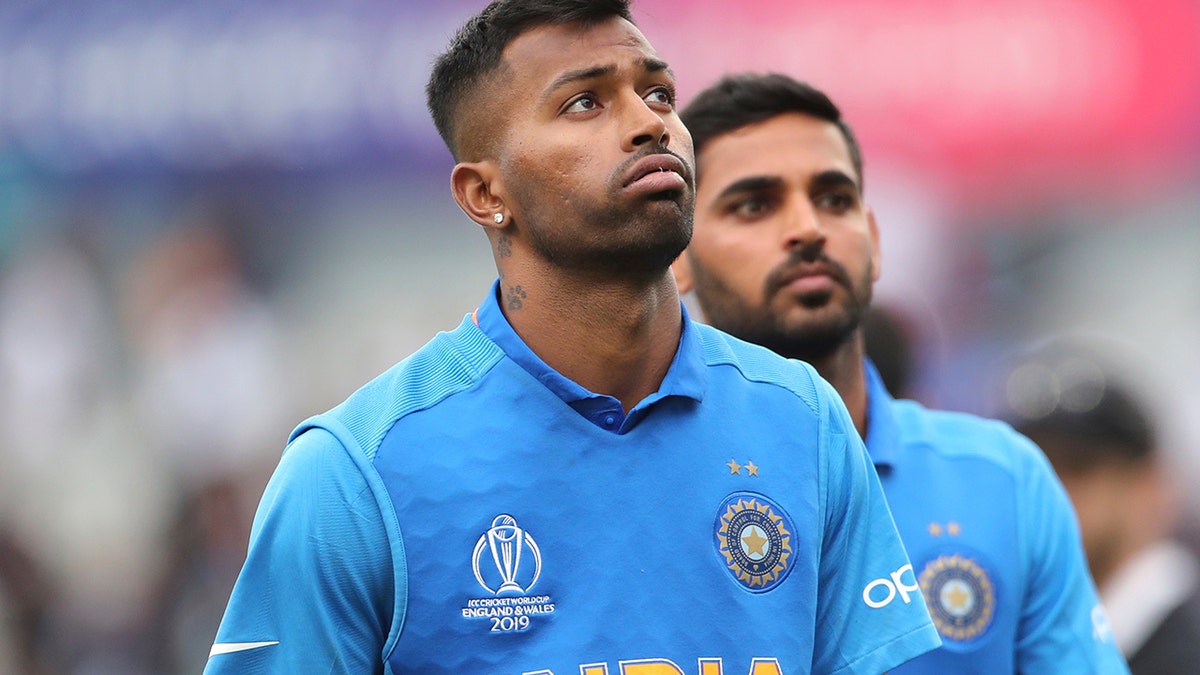 India's Hardik Pandya, left, reacts after their loss in the Cricket World Cup semi-final match against New Zealand at Old Trafford in Manchester, England, Wednesday, July 10, 2019. (AP Photo/Aijaz Rahi)