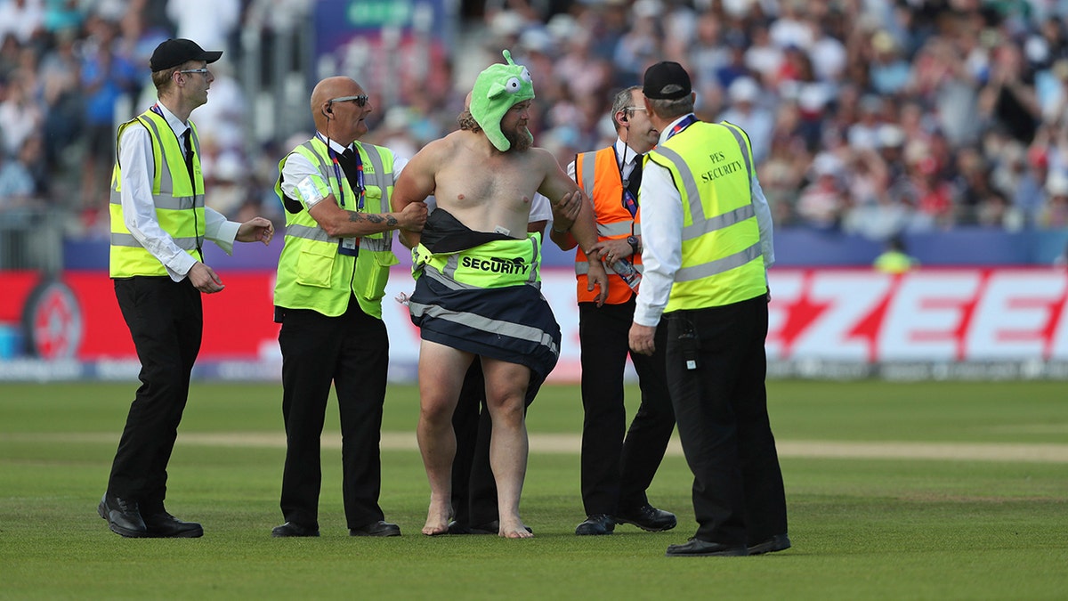 A streaker runs into the field during the Cricket World Cup match between New Zealand and England in Chester-le-Street, England, Wednesday, July 3, 2019. (AP Photo/Scott Heppell)