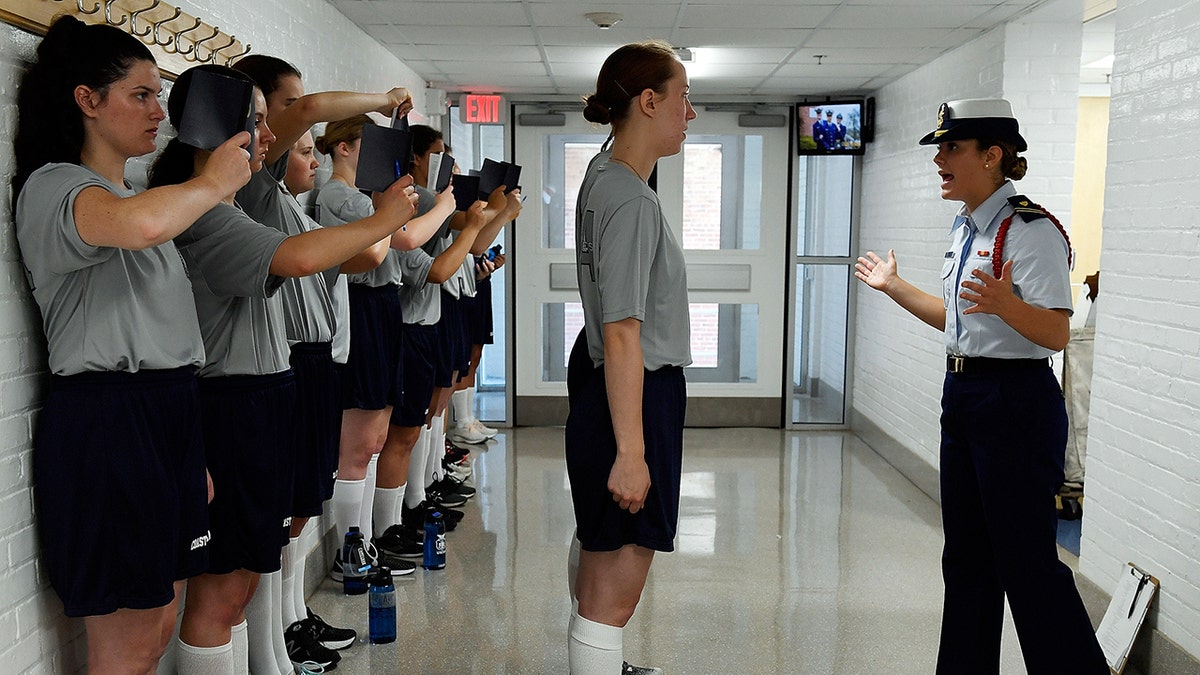 Yankee 2 company Cadre Mary Budri, right, puts female swabs through their paces during Day One of Swab Summer at the U.S. Coast Guard Academy Monday. (Sean D. Elliot/The Day via AP)