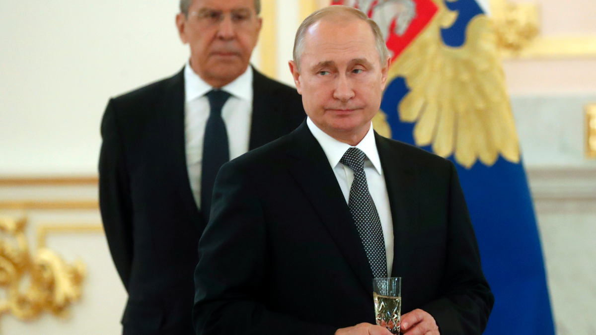 Russian President Vladimir Putin, center, and Russian Foreign Minister Sergei Lavrov attend a ceremony to receive credentials from newly appointed foreign ambassadors to Russia in Kremlin, Moscow, Russia, Wednesday, July 3, 2019. (Maxim Shipenkov/Pool Photo via AP)
