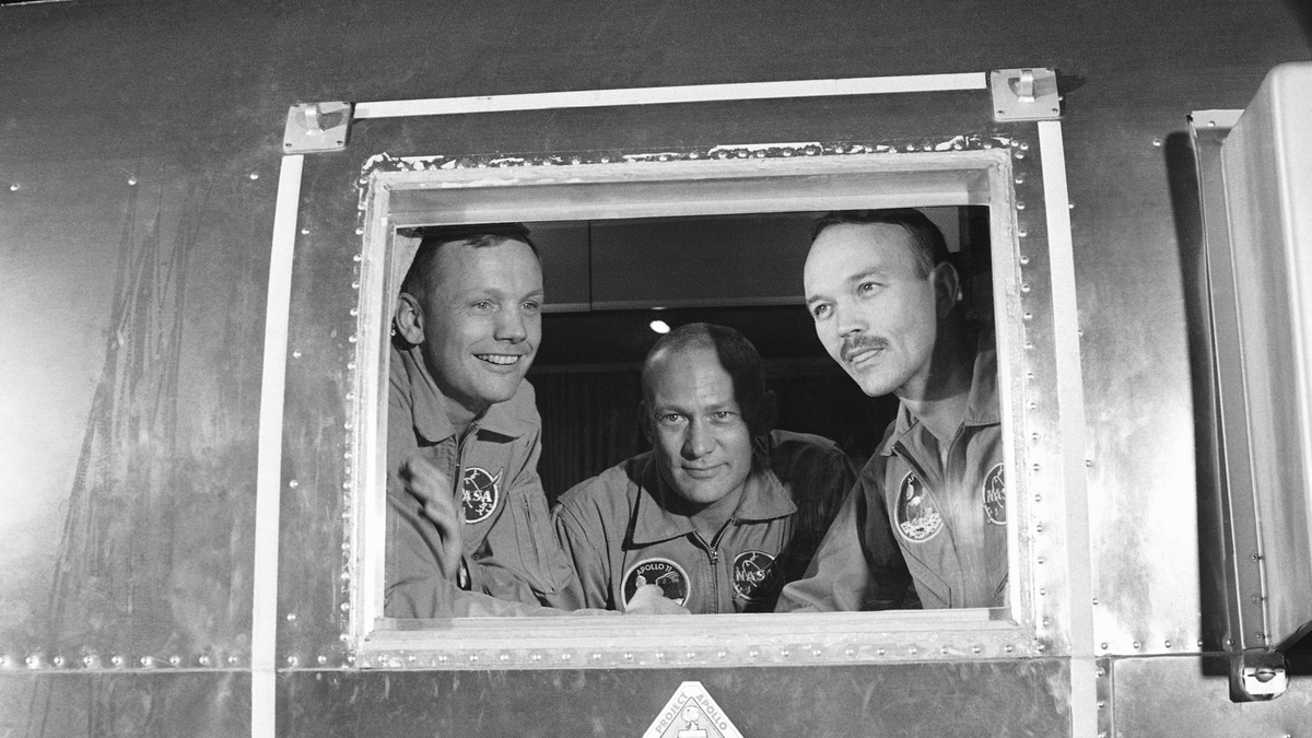 FILE - In this file photo, Apollo 11 crew members, from left, Neil Armstrong, Buzz Aldrin and Michael Collins sit inside the MQF in Houston.