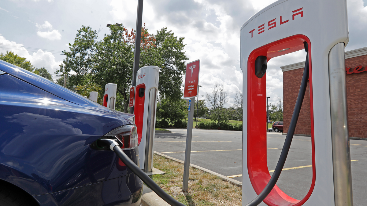 photo of a Tesla vehicle charging at a Tesla Supercharger site