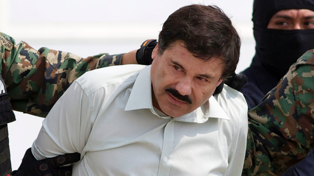 FILE - In this Feb. 22, 2014 file photo, Joaquin "El Chapo" Guzman, the head of Mexico's Sinaloa Cartel, is escorted to a helicopter in Mexico City following his capture in the beach resort town of Mazatlan. (AP Photo/Eduardo Verdugo, File)