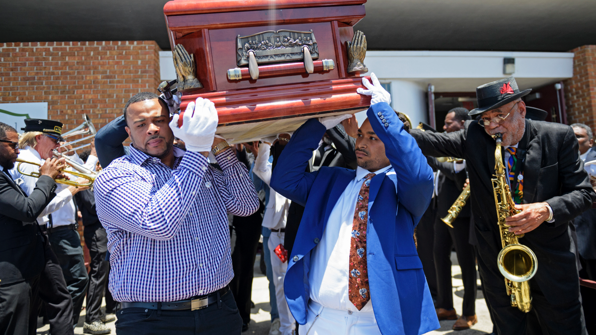 Pallbearers carry the coffin of Dave Bartholomew past the Treme brass band as they exit St. Gabriel the Archangel Church at the conclusion of his funeral in New Orleans, La. Monday, July 8, 2019. The life of Dave Bartholomew, a trumpeter, bandleader, producer, arranger, composer and star-maker of Fats Domino, Lloyd Price and many other New Orleans talents, was celebrated with prayers, tributes, brass bands and dancing. He died at 100 years of age on June 23.