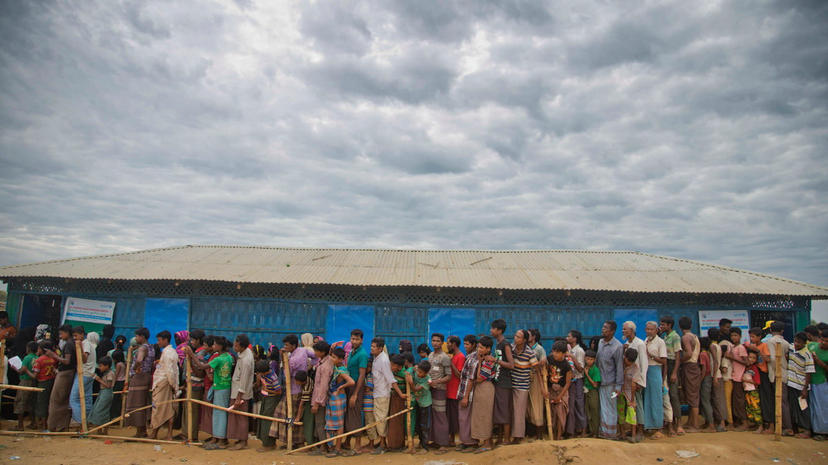 In this Nov. 15, 2017, file photo, Rohingya Muslims, who crossed over from Myanmar into Bangladesh, wait in queues to receive aid at Kutupalong refugee camp in Ukhiya, Bangladesh.