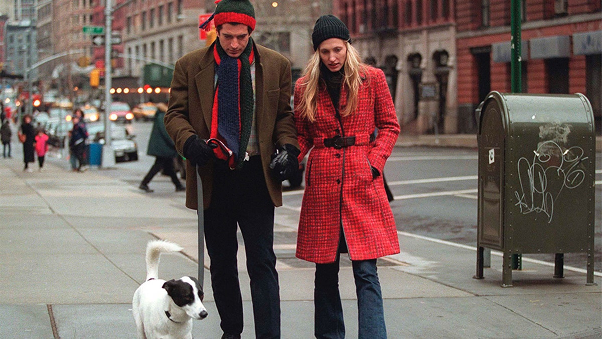 John F. Kennedy Jr. and his wife, Carolyn, walk with their dog January 1, 1997, in New York City. 
