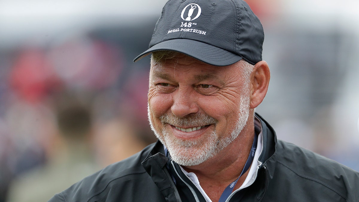 Northern Ireland's Darren Clarke smiles as he speaks to colleagues don the practice range ahead of the start of the British Open golf championships at Royal Portrush in Northern Ireland, Wednesday, July 17, 2019. The British Open starts Thursday. Clarke will hit the first ball at the start of the Open Thursday. (AP Photo/Matt Dunham)