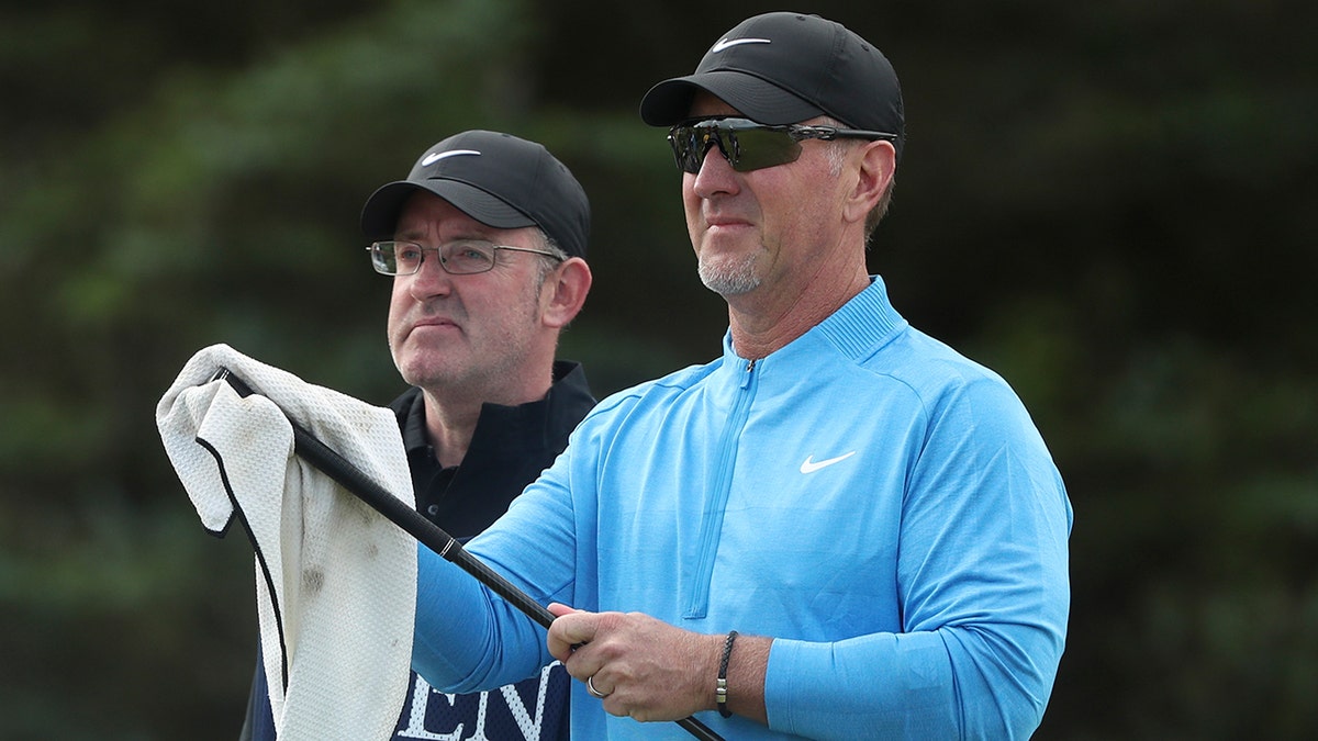 David Duval of the United States cleans one of his clubs as he waits to play on the 5th tee during the first round of the British Open Golf Championships at Royal Portrush in Northern Ireland, Thursday, July 18, 2019. (AP Photo/Jon Super)