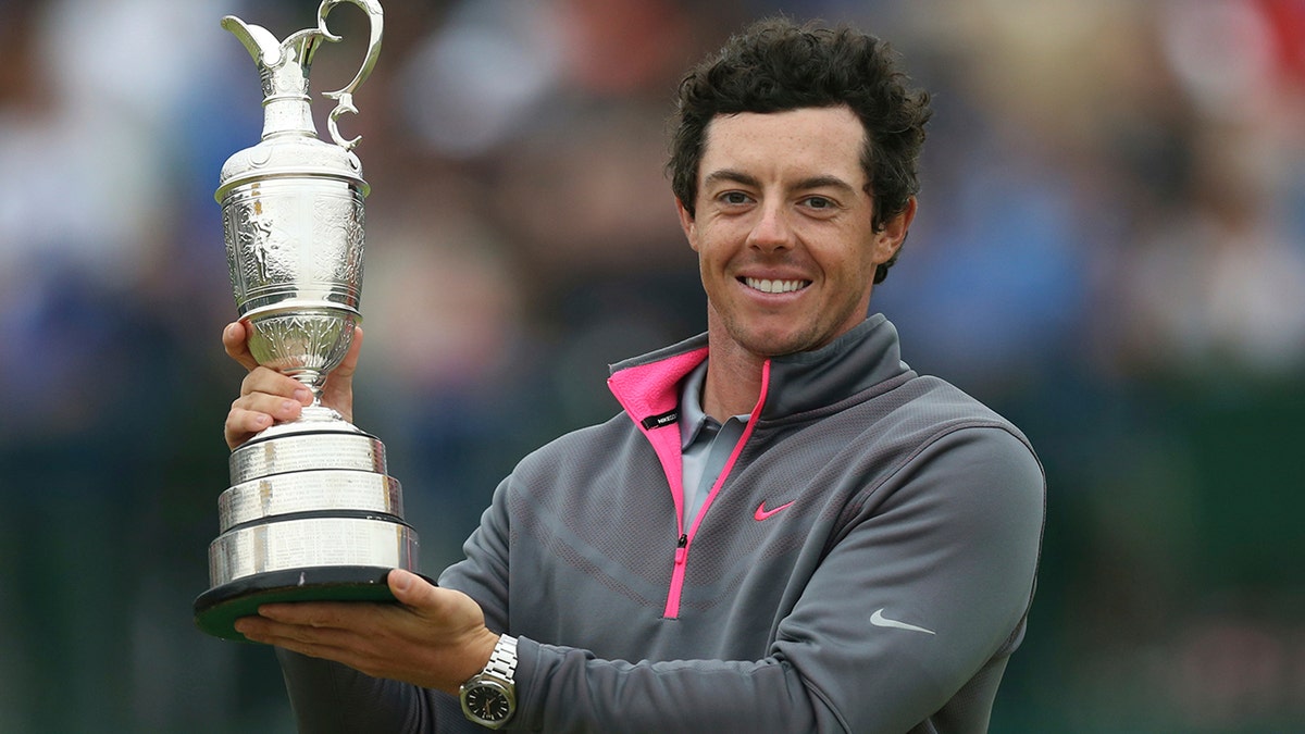 FILE - In this Sunday, July 20, 2014, file photo, Rory McIlroy of Northern Ireland holds up the Claret Jug trophy after winning the British Open Golf championship at the Royal Liverpool in Hoylake, England. McIlroy is among the favorites to win the British Open when it returns to Northern Ireland for the first time in 68 years. (AP Photo/Scott Heppell, File)