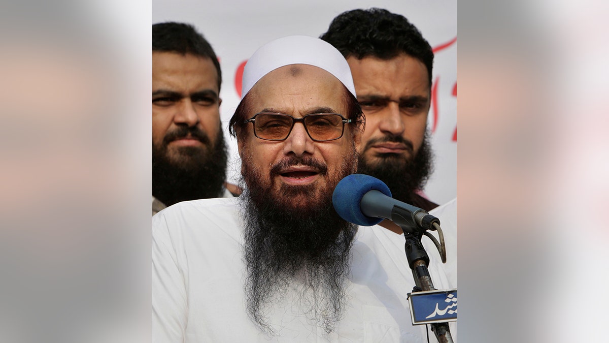 FILE - In this Friday, Oct. 26, 2018 file photo, Hafiz Saeed, founder of Pakistani religious group Jamaat-ud-Dawa addresses an anti-Indian rally in Lahore, Pakistan.  (AP Photo/K.M. Chaudary, File)