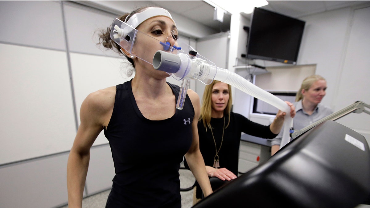 Research scientist Leila Walker, left, assisted by nutritional physiologist Holly McClung, center, as they demonstrated equipment designed to evaluate fitness levels in female soldiers, not shown, this past April at the U.S. Army Combat Capabilities Development Command Soldier Center in Natick, Mass. (AP Photo/Steven Senne)