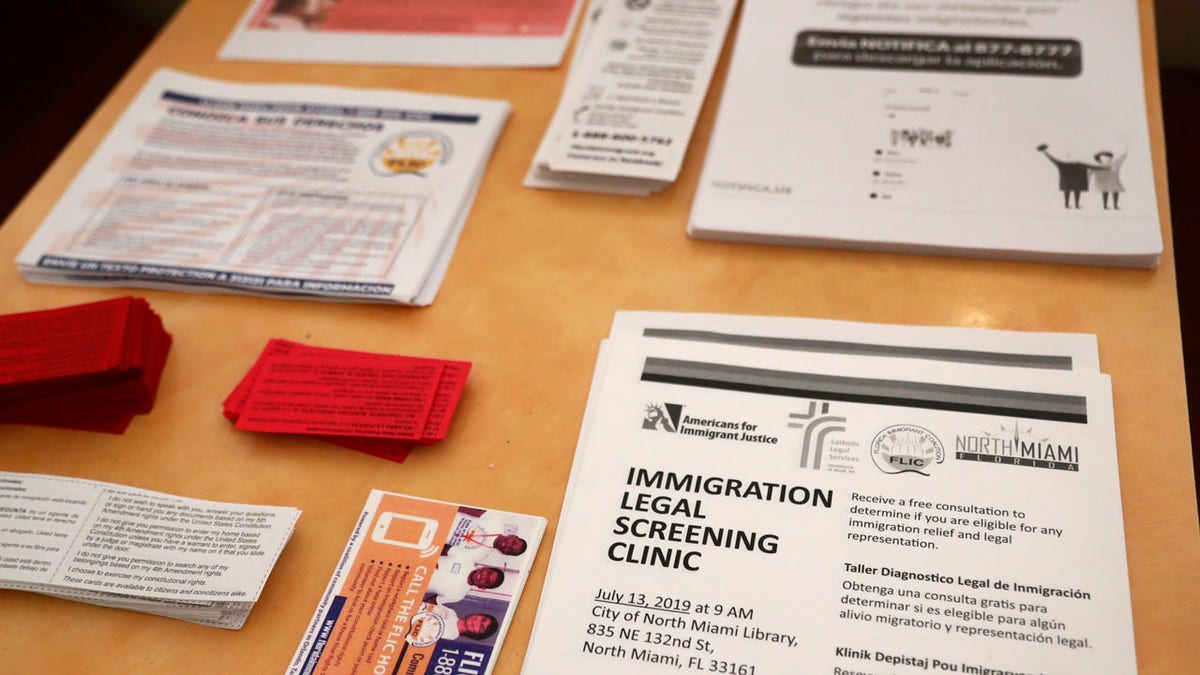 Flyers in English and Spanish are shown stacked at a nearby restaurant before immigration advocates gather them and hand them out, Thursday, July 11, 2019, in the Little Havana neighborhood in Miami.