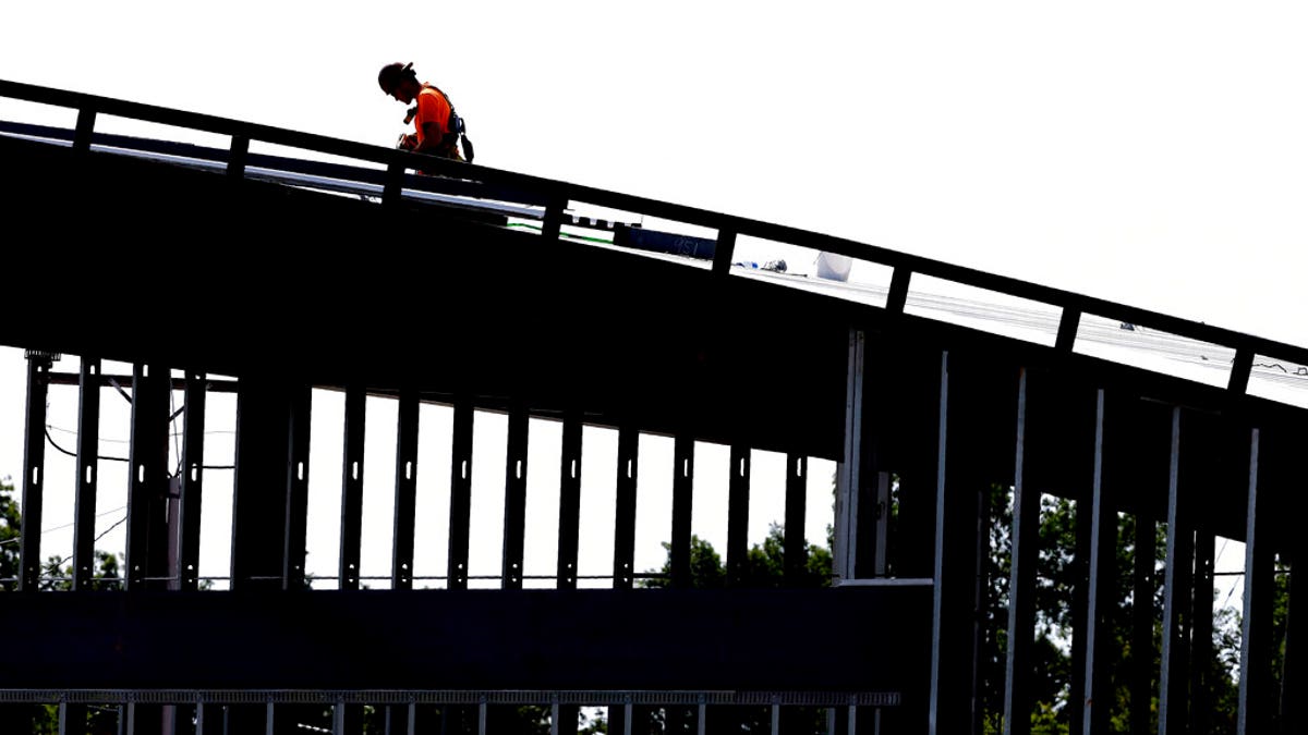 This photo taken Monday, July 1, 2019 shows a worker atop a new building under construction in Hillsborough, N.C. On Friday, July 5, the U.S. government issues the June jobs report. (AP Photo/Gerry Broome)