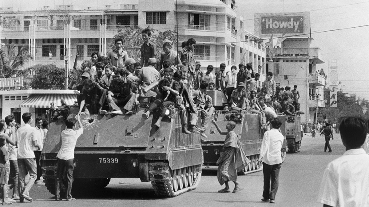 Khmer Rouge soldiers atop US-made armored vehicles in Phnom Penh, Cambodia, in April 1975. (SJOBERG/AFP/Getty Images, File)