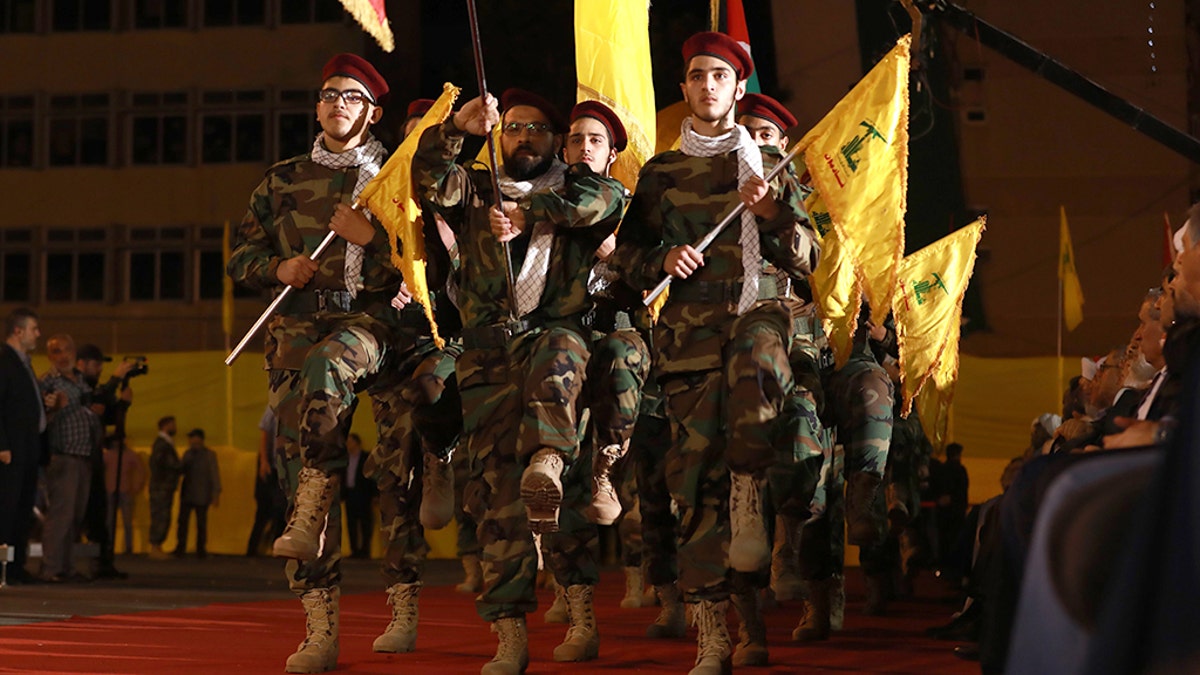 Fighters with the Lebanese Shiite Hezbollah party, carry flags as they parade in a southern suburb of the capital Beirut, to mark the al-Quds (Jerusalem) International Day, on May 31, 2019.