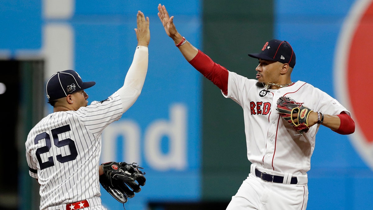 American League Gleyber Torres, left, of the New York Yankees, and American League Mookie Betts, of the Boston Red Sox, celebrate a 4-3 victory of the National League in the MLB baseball All-Star Game, Tuesday, July 9, 2019, in Cleveland. (AP Photo/Tony Dejak)