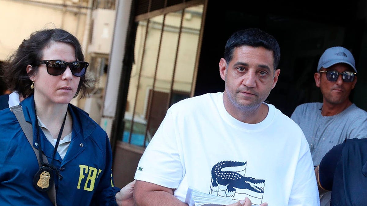 Suspect Thomas Gambino, right, is taken into custody during an anti-mafia operation lead by the Italian Police and the FBI in Palermo, Southern Italy, Wednesday, July 17, 2019. Italian police and the FBI arrested 19 suspected Mafiosi in a joint operation Wednesday following an investigation which revealed alleged ties between Sicily's Cosa Nostra Mafia and New York's Gambino crime family.